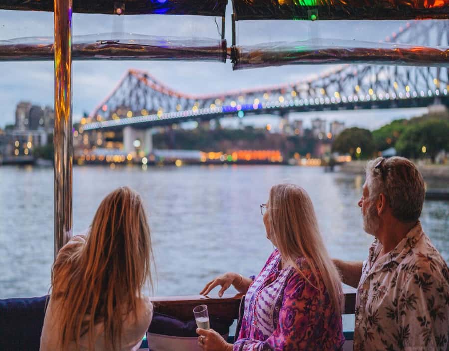 Brisbane: Sunset City Lights Cruise 5.30pm or 6pm <em>seasonal – Key points before you book’ /></p>
<ul>
<li><strong>Story Bridge after dark:</strong> The route gives you a fine river-level view of Brisbane’s best-known bridge as it takes on the evening lights.</li>
<li><strong>Kangaroo Cliffs from the river:</strong> The cliffs offer a change from the high-rise views and make the trip feel like more than a skyline loop.</li>
<li><strong>A complimentary charcuterie board:</strong> This is more than a token snack and helps make the fare feel fair, especially if you order only one drink.</li>
<li><strong>Sunset timing changes by season:</strong> Winter departures are at 5.30pm, while summer departures are at 6pm.</li>
<li><strong>Music instead of narration:</strong> Background music keeps the mood calm, but you will need another tour if you want detailed facts about Brisbane.</li>
<li><strong>A relaxed 90 minutes:</strong> The cruise suits date nights, families, older visitors, and anyone wanting a gentle break from busy sightseeing.</li>
</ul>
<h2 id="meeting-the-boat-at-south-bank">Meeting the boat at South Bank</h2>
<p><img width="900" height="675" decoding="async" src=