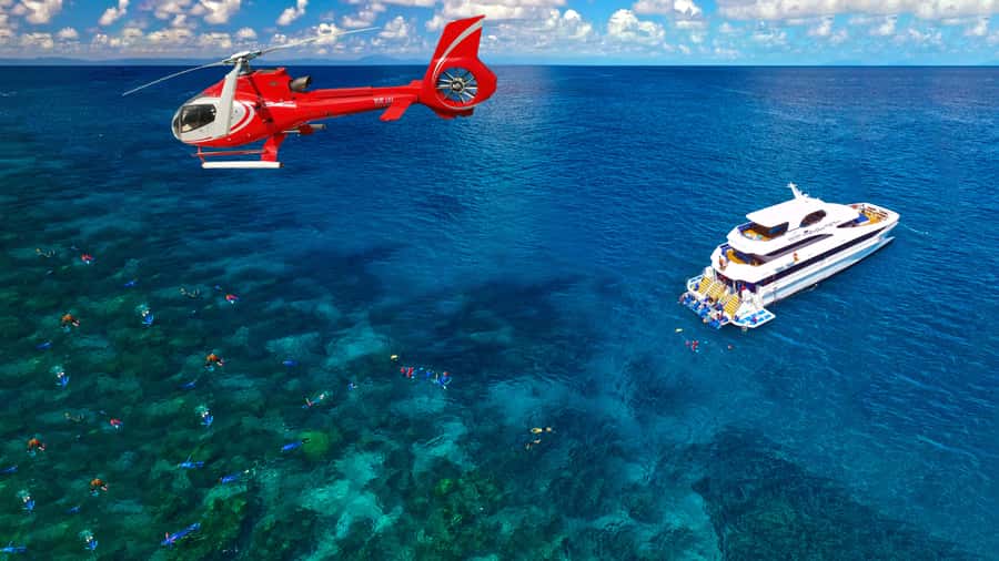 Cairns: Great Barrier Reef Cruise & Scenic Helicopter Flight - Returning to Cairns with wine and snacks