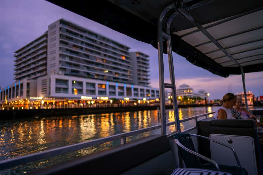 Cairns: Sunset River Cruise with Snack and Drinks - Golden light, cloudy skies, and the changing city