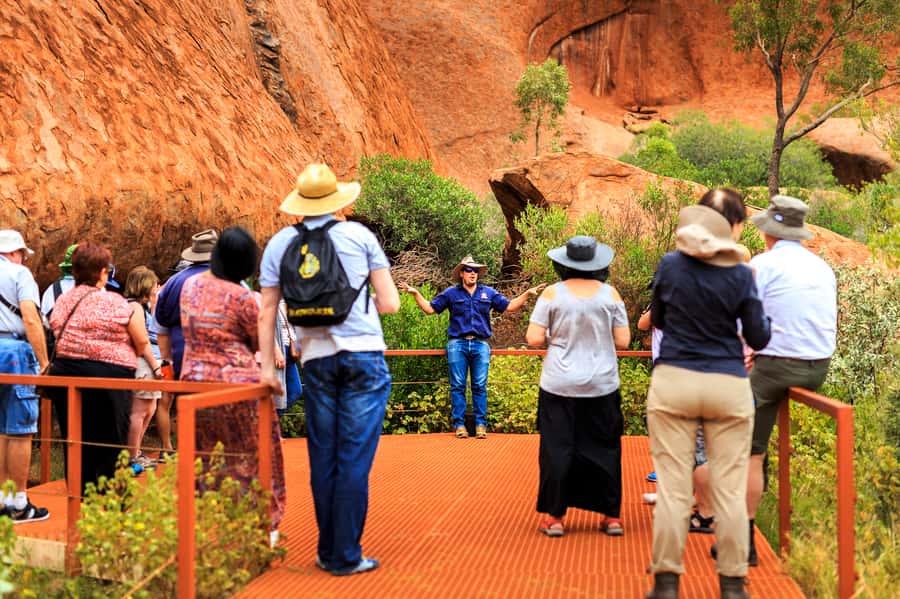 From Yulara: Uluru Tour and Sunset BBQ - Mutitjulu Waterhole adds water, caves, and ceremony