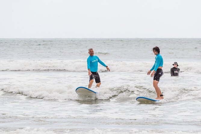 Learn to Surf at Noosa on the Sunshine Coast - Catching the first waves in waist-deep water